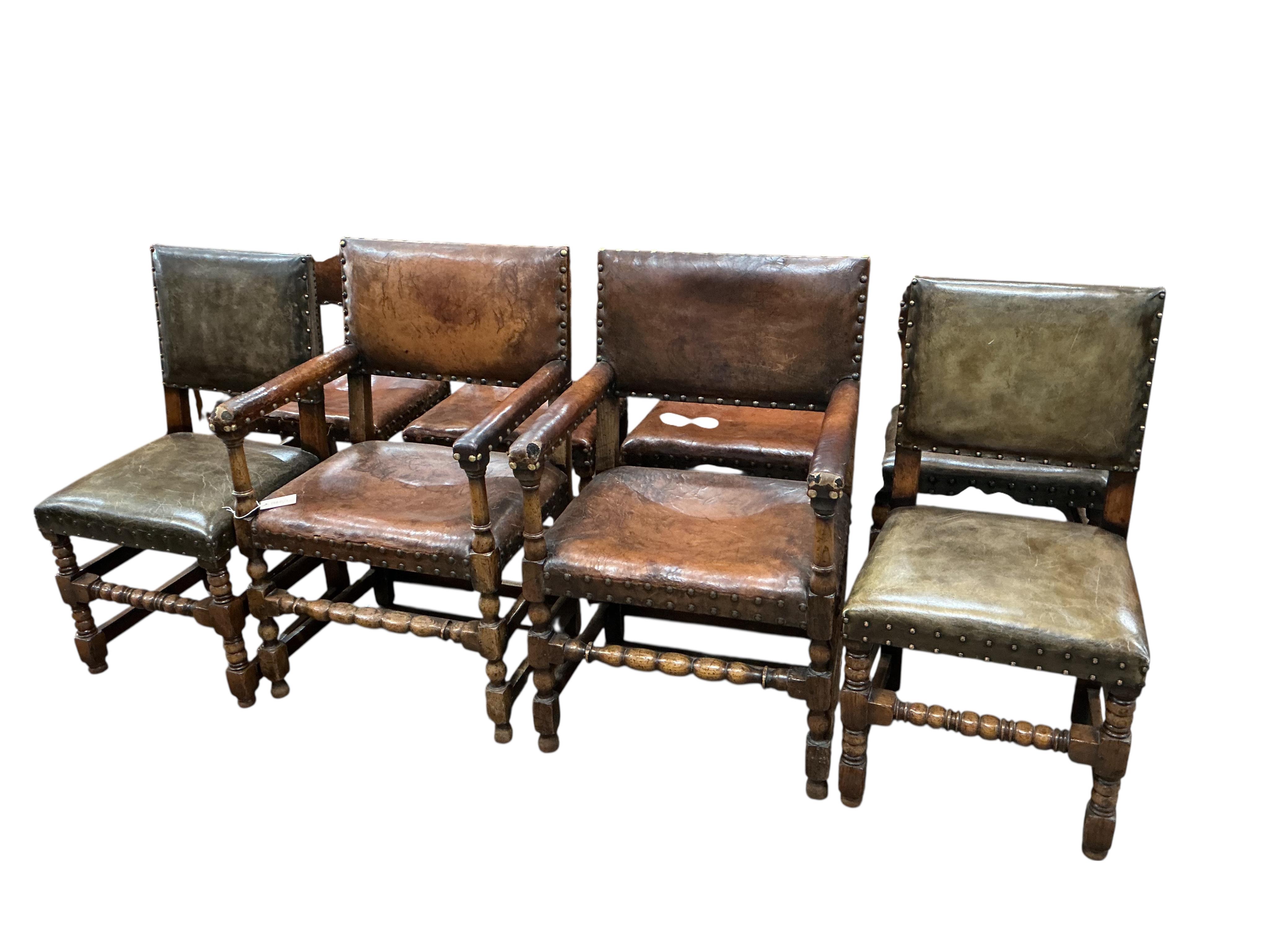 A set of eight Cromwellian style oak and tan leather dining chairs, two with arms